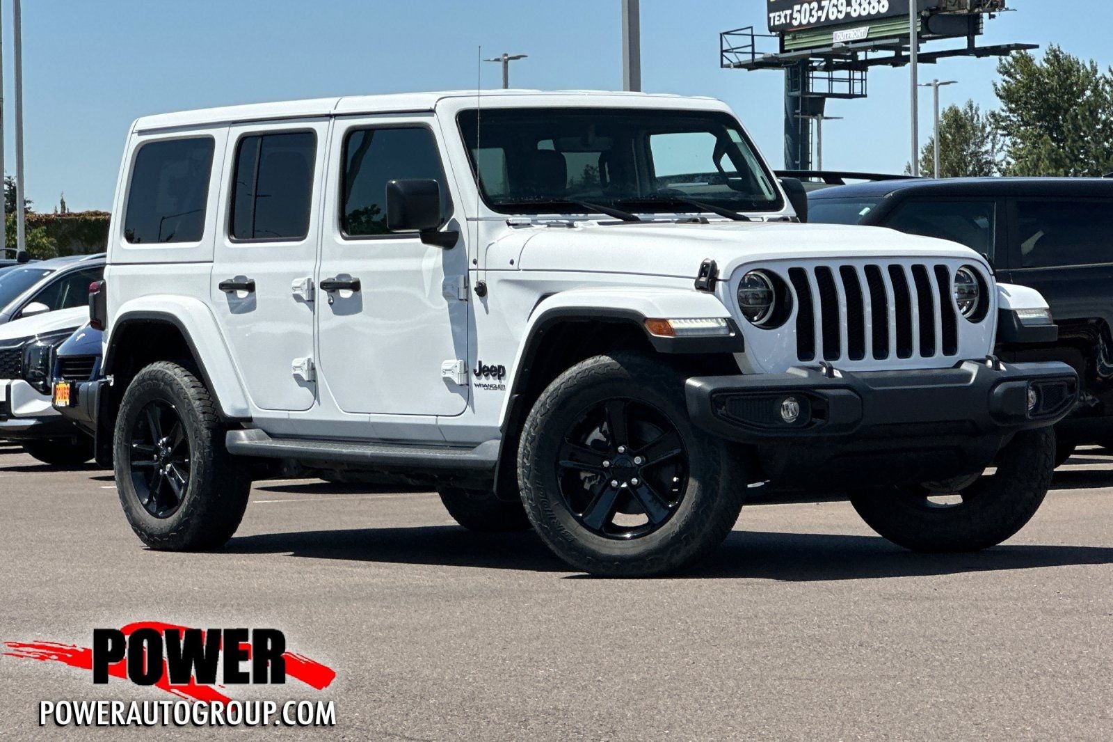2022 Jeep Wrangler Unlimited Sahara Altitude in Bright White Clearcoat — front three-quarter view