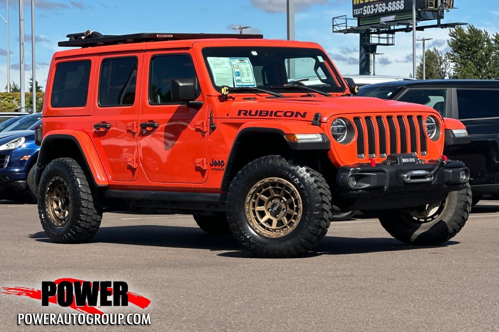 2020 Jeep Wrangler Unlimited Rubicon in Punkn Metallic Clearcoat — front three-quarter view