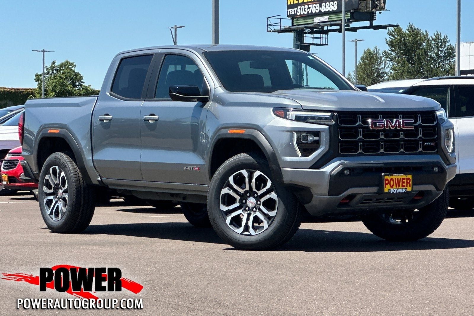 2024 GMC Canyon AT4 in Sterling Metallic — front three-quarter view
