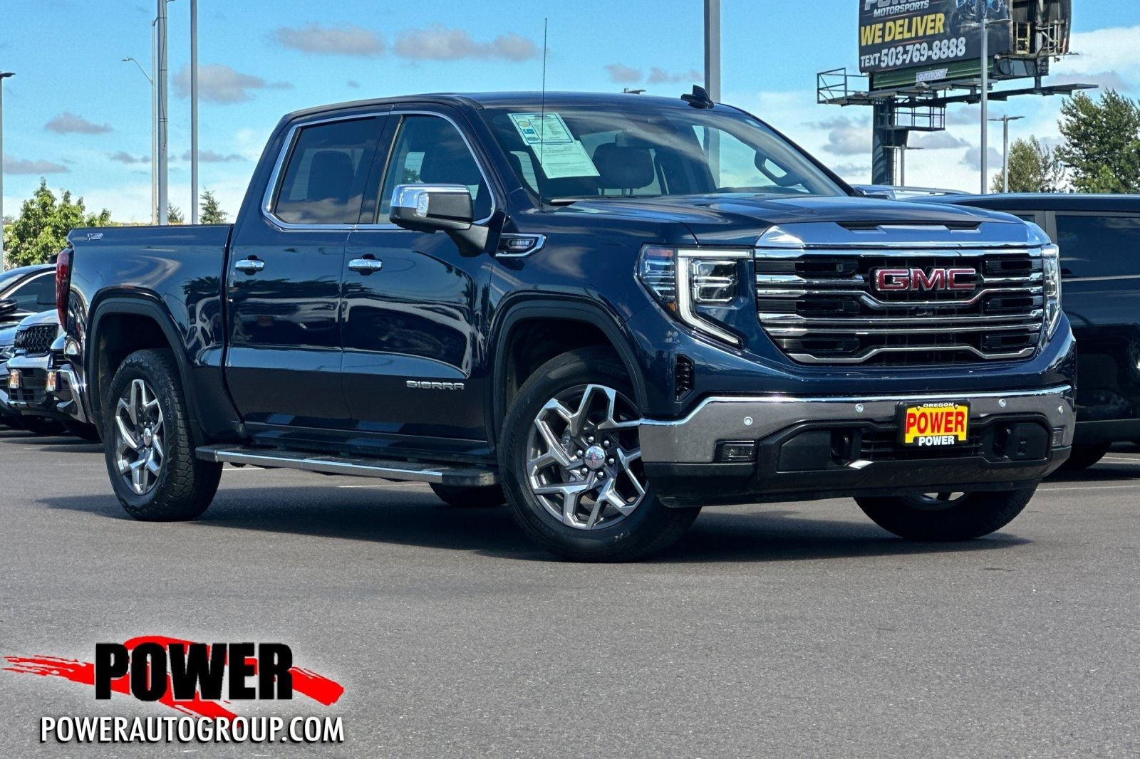 2023 GMC Sierra 1500 SLT in Pacific Blue Metallic — front three-quarter view