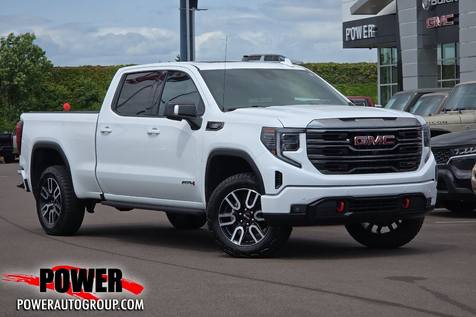 2022 GMC Sierra 1500 AT4 in Summit White — front three-quarter view