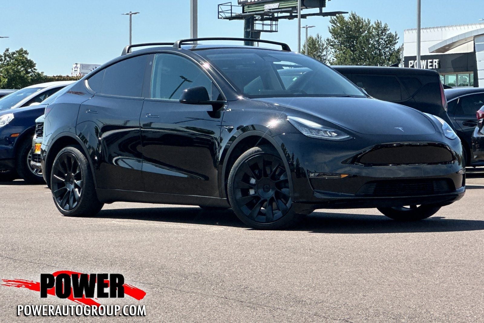 2022 Tesla Model Y Long Range in Solid Black — front three-quarter view