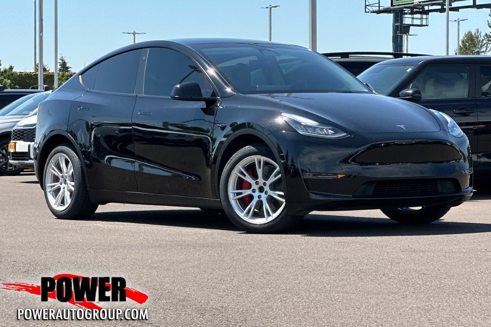 2023 Tesla Model Y Long Range in Solid Black — front three-quarter view