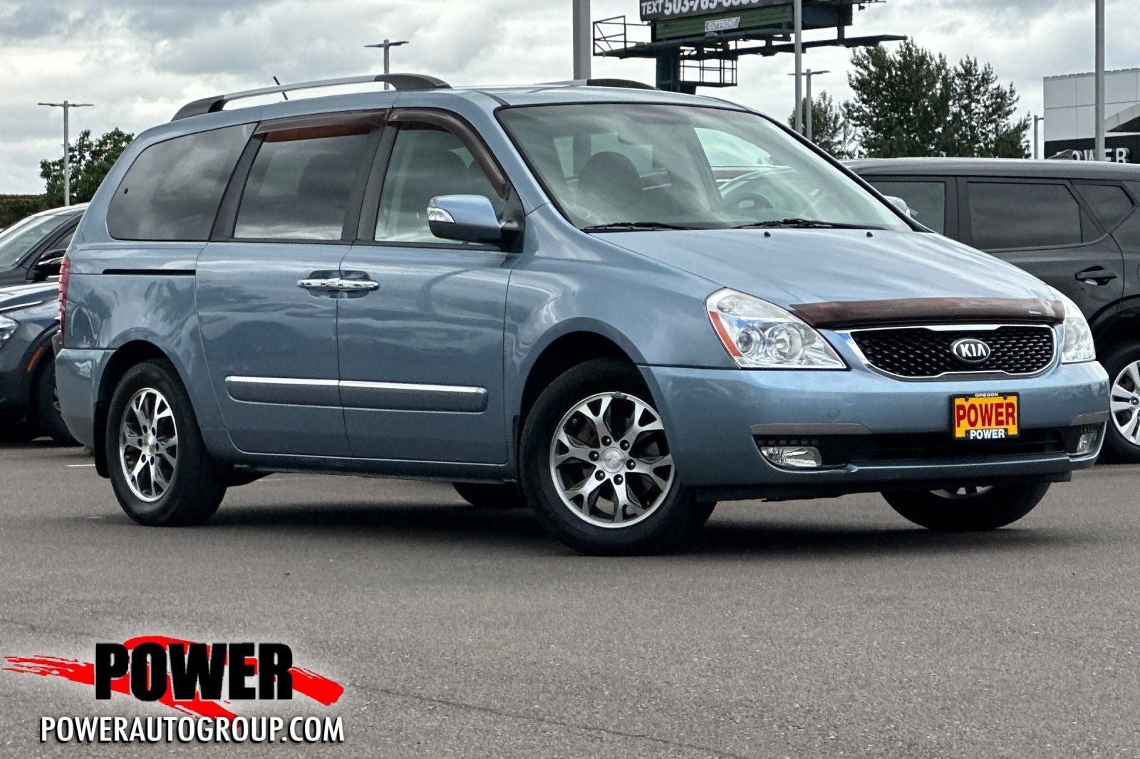 2014 Kia Sedona EX in Glacier Blue — front three-quarter view