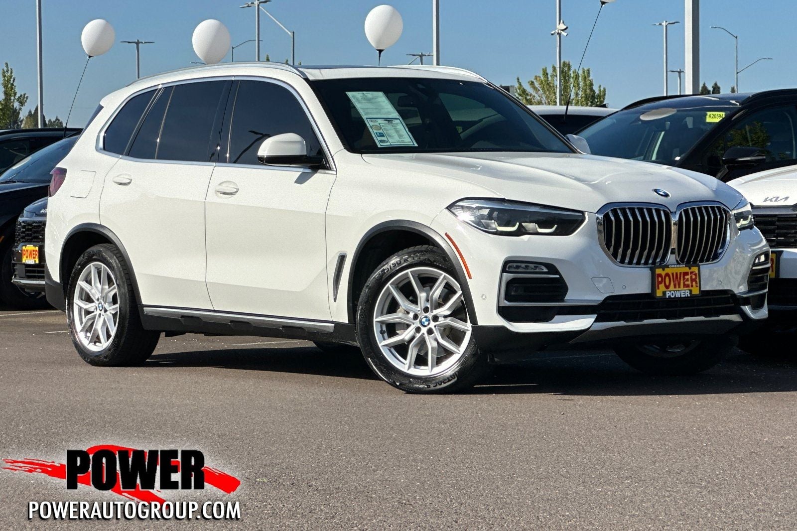 2021 BMW X5 xDrive40i in Alpine White — front three-quarter view