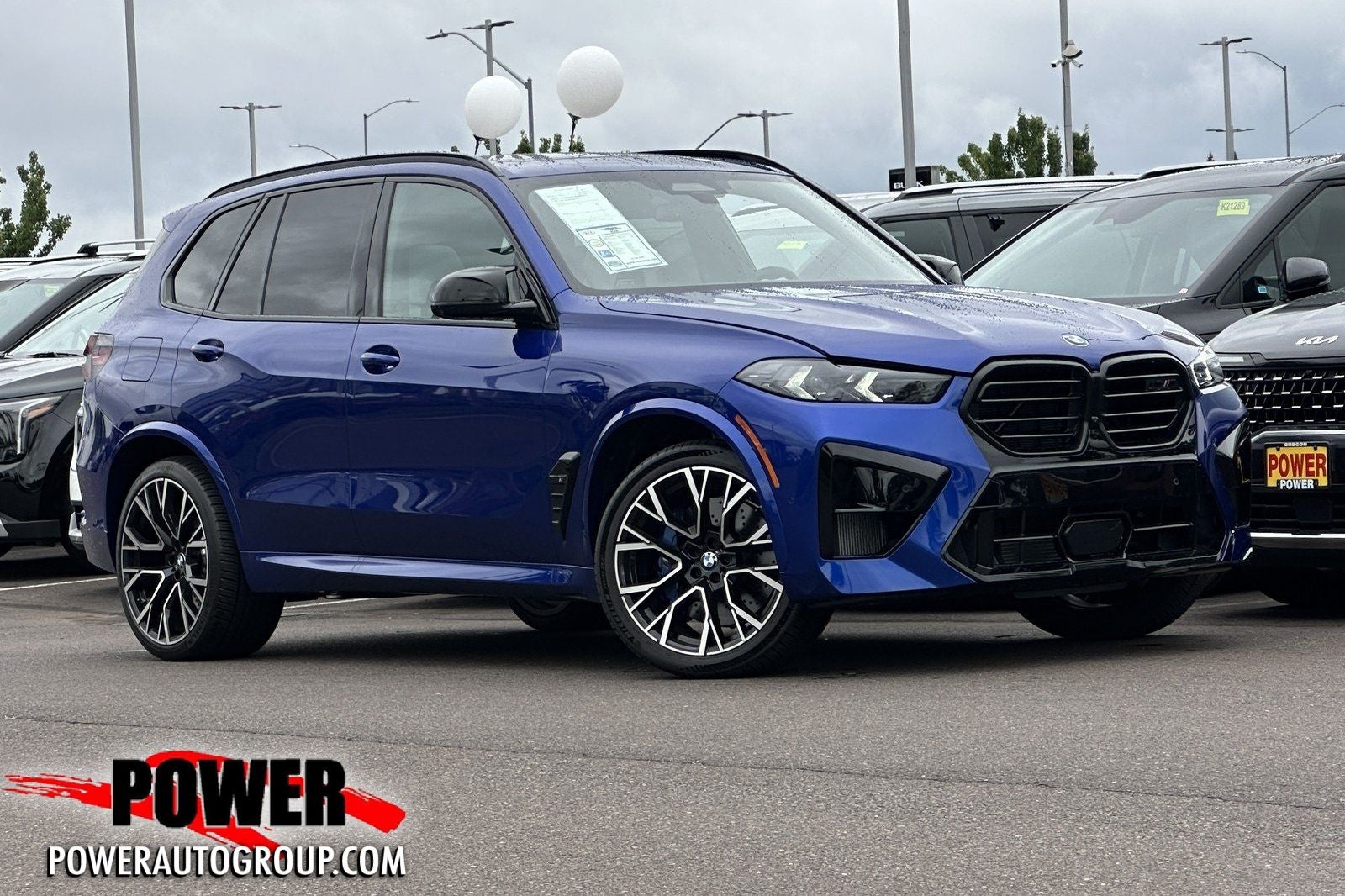 2026 BMW X5 M Competition in Marina Bay Blue Metallic — front three-quarter view