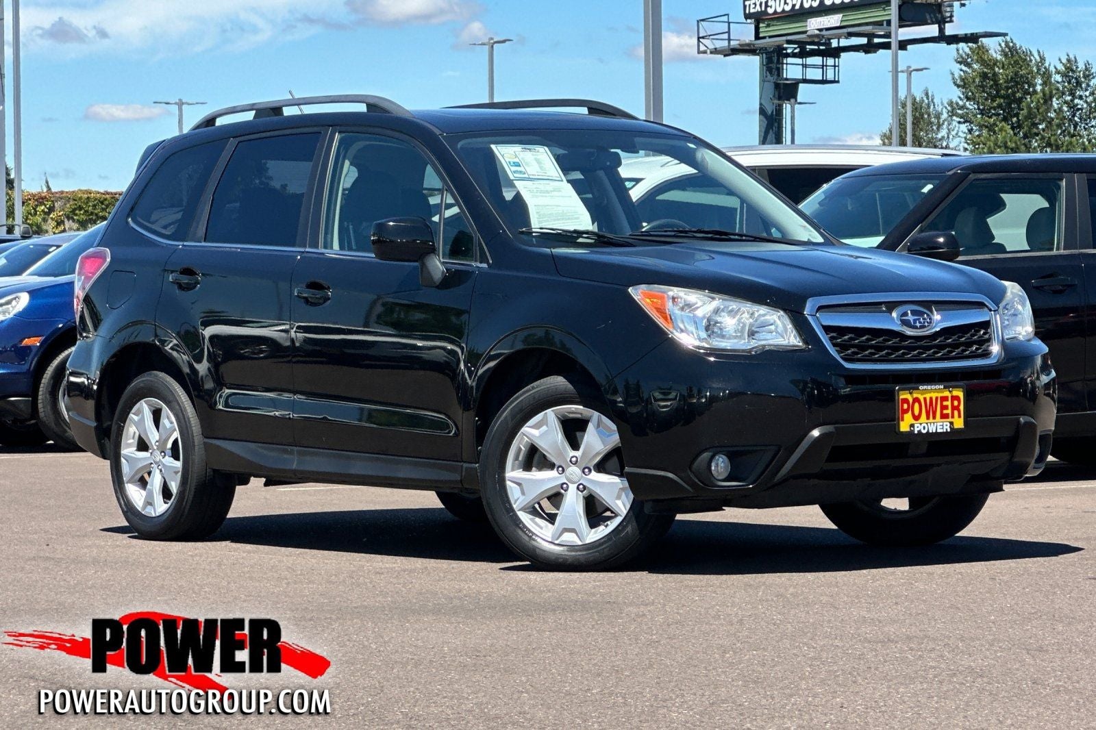 2014 Subaru Forester 2.5i Limited in Crystal Black Silica — front three-quarter view