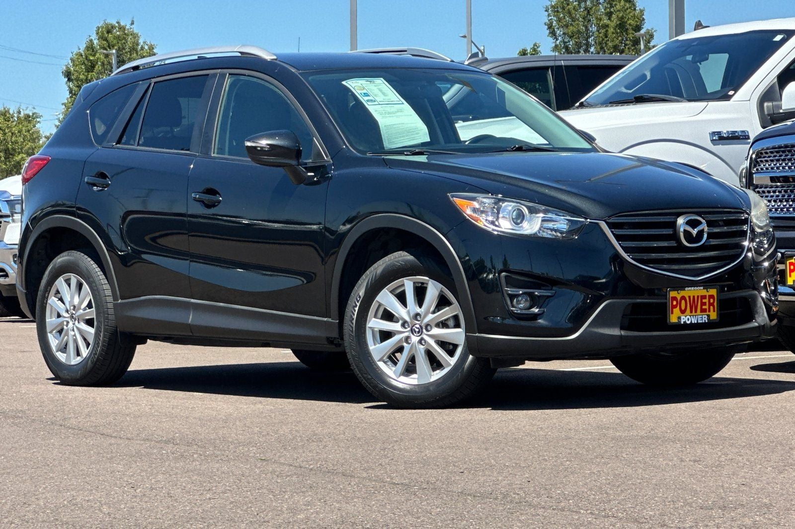 2016 Mazda Mazda CX-5 Touring in Jet Black Mica — front three-quarter view