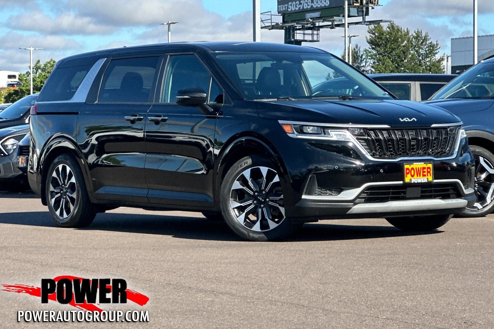 2022 Kia Carnival EX in Aurora Black — front three-quarter view